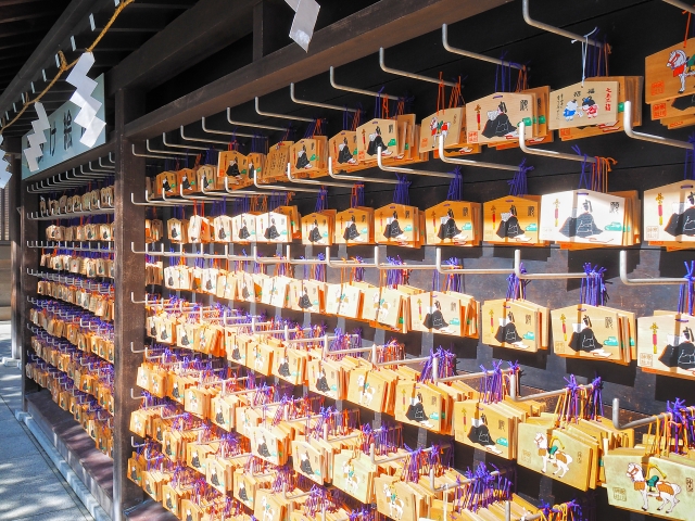 Rows of Ema plaques featuring Sugawara no Michizane, the deity of learning, at a Japanese shrine