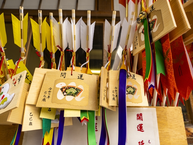 Colorful Hamaya arrows and Ema plaques displayed at a Japanese shrine for New Year's blessings
