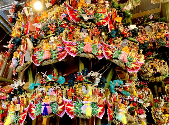 Colorful decorative kumade (lucky rakes) on display at a Tori-no-Ichi festival stall in Japan