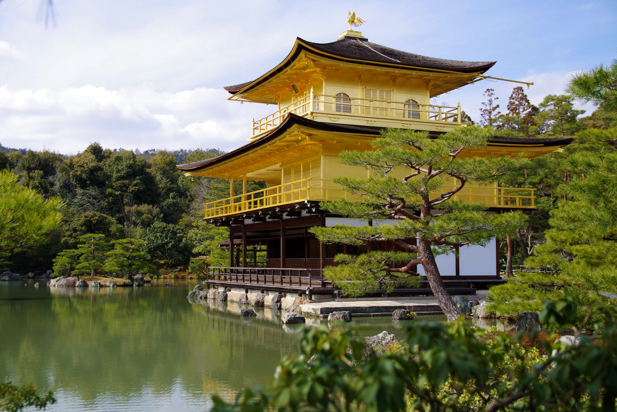 Golden Pavilion (Kinkaku-ji) reflected in the pond on a clear day in Kyoto